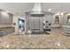 Granite kitchen island with a cooktop and stainless steel appliances at 15300 Water Oak Ct, Punta Gorda, FL 33982