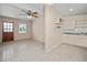 Open living and kitchen area with tile flooring and ceiling fan at 3372 Lucerne Ter, Port Charlotte, FL 33952