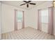 Simple bedroom with tiled floors and pink curtains at 3372 Lucerne Ter, Port Charlotte, FL 33952