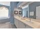 Double vanity bathroom with light blue walls and a soaking tub at 1708 Palace Ct, Punta Gorda, FL 33980
