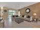 Bright living room with neutral colored sofas and tiled floors at 1708 Palace Ct, Punta Gorda, FL 33980