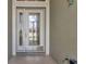 Front door with glass inserts and sidelight at 1708 Palace Ct, Punta Gorda, FL 33980