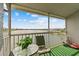 Spacious screened balcony with lake view, seating, and lush greenery at 3310 Loveland Blvd # 2505, Punta Gorda, FL 33980