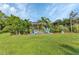 Landscaped backyard with patio furniture and grassy lawn at 5034 Hightower Rd, North Port, FL 34288