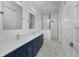 Modern bathroom with navy blue vanity and hexagon tile floor at 1200 Gorda Cay Ln, Punta Gorda, FL 33950