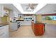 Kitchen with white cabinets, granite island, and breakfast bar at 4041 Michel Tree St, Port Charlotte, FL 33948