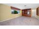 Spacious living room with built-in shelving and tile floors at 4041 Michel Tree St, Port Charlotte, FL 33948
