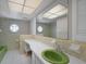 Retro bathroom with green sink and tile details at 4041 Michel Tree St, Port Charlotte, FL 33948