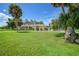 Yellow house exterior with palm trees and landscaped yard at 4041 Michel Tree St, Port Charlotte, FL 33948