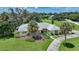 Single-story home with light-colored facade, palm trees, and a well-manicured lawn at 4041 Michel Tree St, Port Charlotte, FL 33948