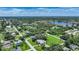 Aerial view showcasing the property and surrounding area, including water features and abundant green space at 4041 Michel Tree St, Port Charlotte, FL 33948