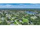 Aerial view showcasing the property and surrounding area, including water features and abundant green space at 4041 Michel Tree St, Port Charlotte, FL 33948