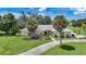 Single-story home with a light-colored facade, palm trees, and a well-manicured lawn at 4041 Michel Tree St, Port Charlotte, FL 33948