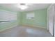 Light green bedroom with tile floors, large closet, and two windows at 4041 Michel Tree St, Port Charlotte, FL 33948