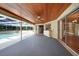 Covered patio with pool access, ceiling fan and adjacent kitchen access at 4041 Michel Tree St, Port Charlotte, FL 33948