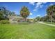 Front view of a charming ranch house with a circular driveway at 4041 Michel Tree St, Port Charlotte, FL 33948