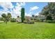 Large backyard with lush lawn and mature landscaping at 4041 Michel Tree St, Port Charlotte, FL 33948