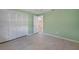 Bedroom with light green walls, tile floors and built-in closet at 4041 Michel Tree St, Port Charlotte, FL 33948