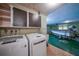 Laundry room with washer, dryer, and cabinets at 4041 Michel Tree St, Port Charlotte, FL 33948