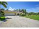 House exterior showcasing a two-car garage and expansive driveway at 4041 Michel Tree St, Port Charlotte, FL 33948