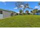 Large backyard with grassy lawn and mature trees at 22473 Hernando Ave, Port Charlotte, FL 33952