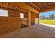 Interior of a barn with wooden stalls and hay feeder at 15300 Water Oak Ct, Punta Gorda, FL 33982