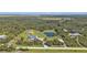 Aerial view of the property showcasing house, pond, and surrounding land at 15300 Water Oak Ct, Punta Gorda, FL 33982