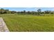 Large grassy backyard with pond and partial fencing at 15300 Water Oak Ct, Punta Gorda, FL 33982