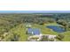 Aerial view of house and surrounding land with pond at 15300 Water Oak Ct, Punta Gorda, FL 33982