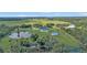Aerial view of a house on a large lot with a pool and pond at 15300 Water Oak Ct, Punta Gorda, FL 33982