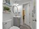 Small bathroom with gray vanity and floating shelves at 15300 Water Oak Ct, Punta Gorda, FL 33982
