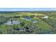 Aerial view of house, pool, and expansive land at 15300 Water Oak Ct, Punta Gorda, FL 33982