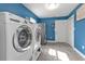 Bright laundry room with washer, dryer, and extra storage at 15300 Water Oak Ct, Punta Gorda, FL 33982