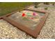 sandbox with toys, surrounded by decorative stones at 843 E 6Th St, Englewood, FL 34223