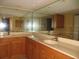 Bathroom with double vanity, large mirrors, and wooden cabinetry at 601 Shreve St # 12B, Punta Gorda, FL 33950