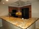 Kitchen with breakfast bar, granite countertops, and black appliances at 601 Shreve St # 12B, Punta Gorda, FL 33950