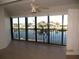 Living room with water views through sliding glass doors and ceiling fan at 601 Shreve St # 12B, Punta Gorda, FL 33950