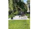 Concrete patio with grill, seating, and umbrella at 2106 Switzerland Rd, North Port, FL 34288