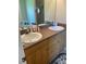 Double vanity bathroom with wood cabinets and a tiled floor at 2106 Switzerland Rd, North Port, FL 34288