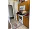 Bright kitchen with wood cabinets, white appliances, and a tiled floor at 2106 Switzerland Rd, North Port, FL 34288