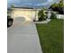 White house with solar panels, driveway, and landscaped lawn at 2106 Switzerland Rd, North Port, FL 34288