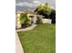 Front yard view of a one-story house with walkway and lush lawn at 2106 Switzerland Rd, North Port, FL 34288