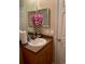 Bathroom features a single vanity, wood cabinets, and a tiled floor at 2106 Switzerland Rd, North Port, FL 34288