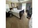 Large bedroom with carpeted floor, a dark wood sleigh bed, and window coverings at 2106 Switzerland Rd, North Port, FL 34288