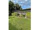 Screened porch and lush landscaping along the back of the house at 2106 Switzerland Rd, North Port, FL 34288