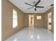 Bedroom with tile floors, ceiling fan, and access to bath at 791 Haleybury St, Port Charlotte, FL 33948