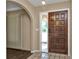 Inviting entryway with tiled floor and wood door at 791 Haleybury St, Port Charlotte, FL 33948