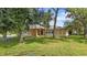 Single-story home with light yellow exterior and large green lawn at 791 Haleybury St, Port Charlotte, FL 33948