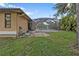 Spacious backyard with grassy area and screened-in pool at 791 Haleybury St, Port Charlotte, FL 33948