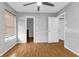 Comfortable bedroom with wood-look floors, ceiling fan, and access to a closet at 791 Haleybury St, Port Charlotte, FL 33948